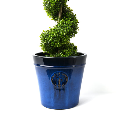 Glazed blue pot with lush green tree